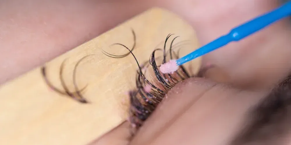 An unsafe DIY lash removal attempt, illustrating the risks of using improper tools and causing mechanical damage.
