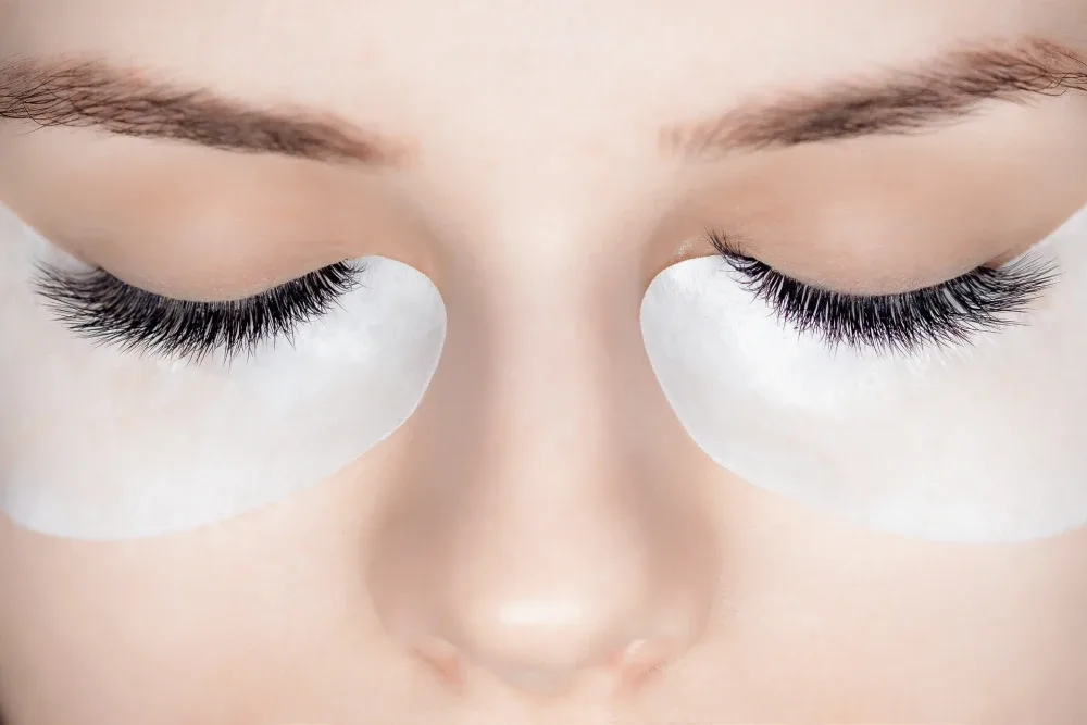 A close-up of a client's eyes showing a finished set of hybrid eyelash extensions, a popular style choice.