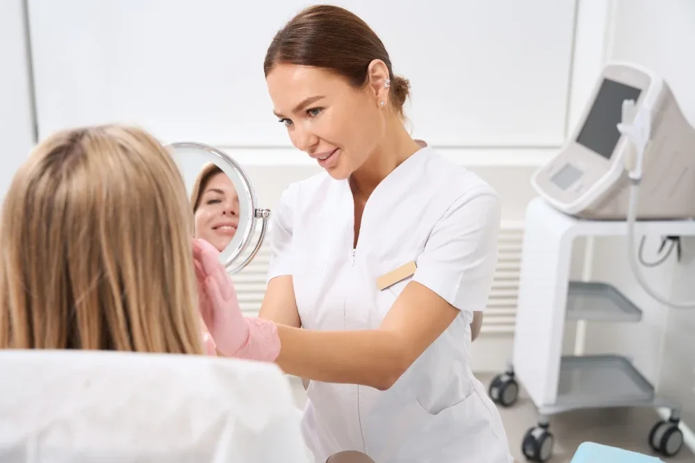 A technician discusses a client's desired lash style during a consultation.