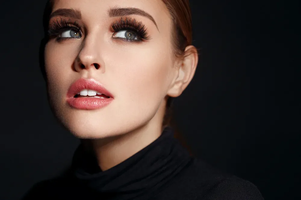 Woman wearing a bold, dramatic style of eyelash extensions.