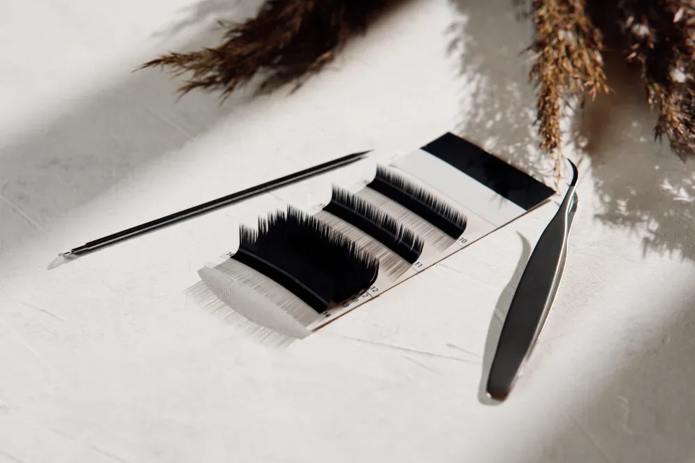 Lash extension strips and tools are arranged for choosing a style during consultation.
