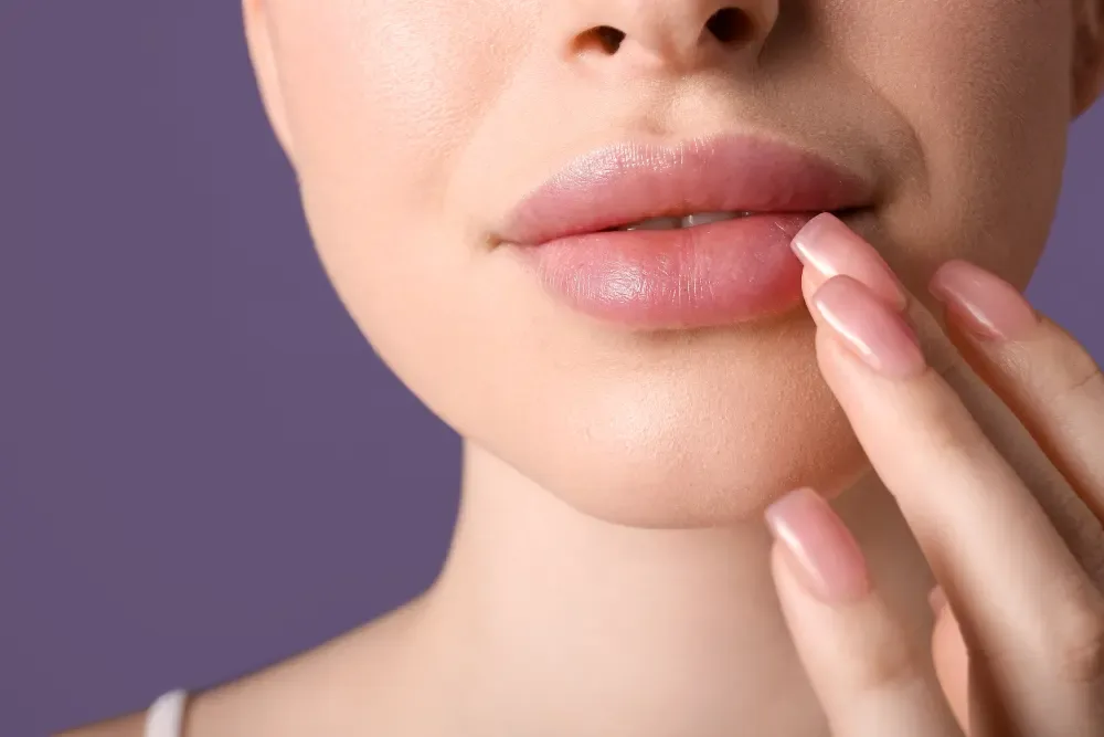 A happy client discusses her options with a specialist, making the final decision in the lip blushing versus fillers debate based on her personal goals.