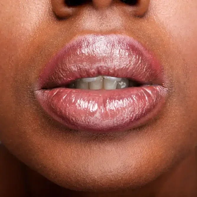 A close-up of lips during the second session of neutralization, where the final target color is applied over the healed base.