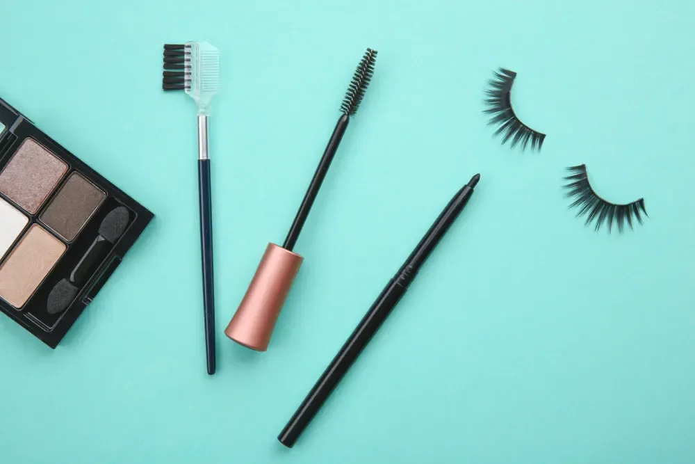 Mascara and eyeliner arranged for a discussion of makeup with lash extensions.