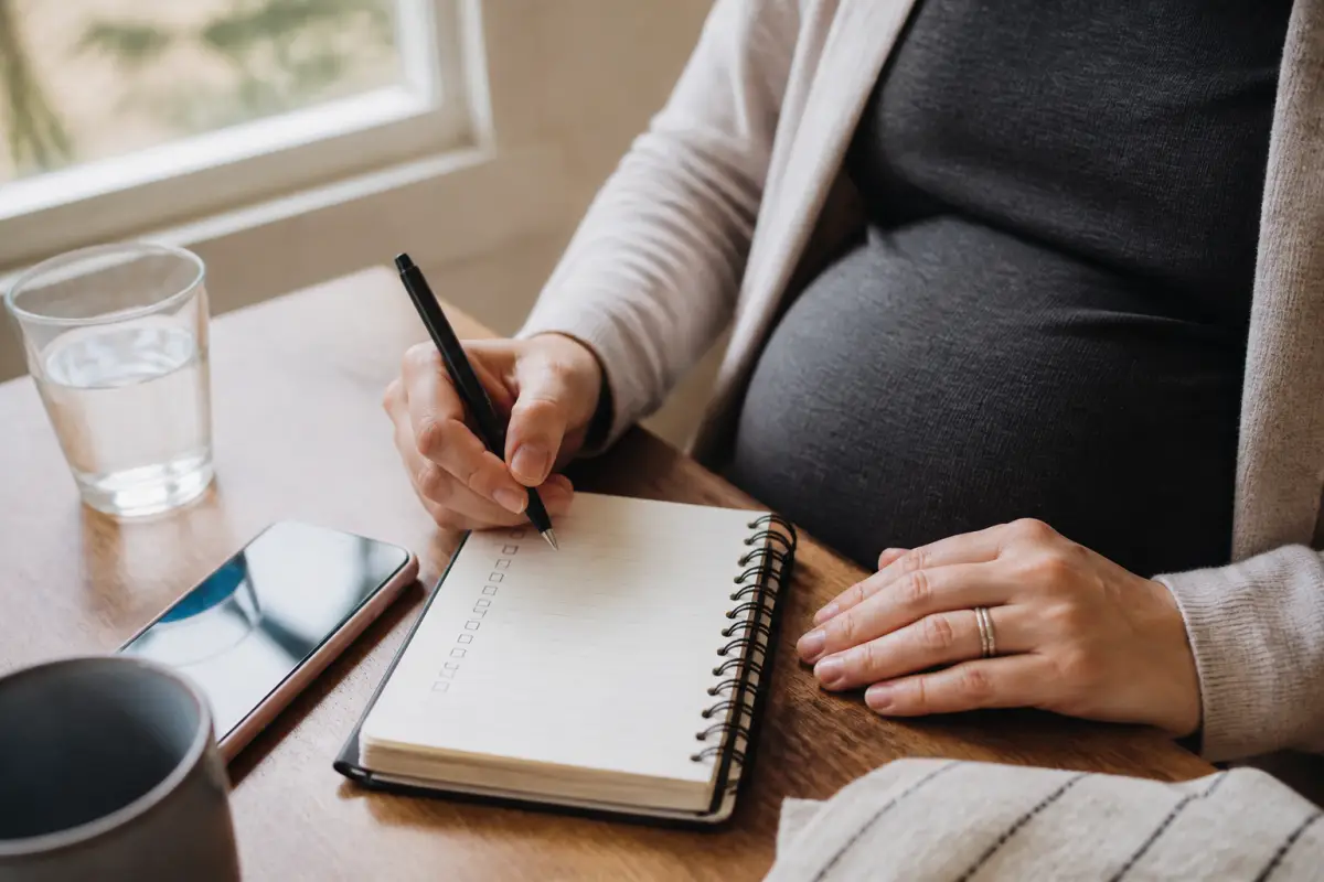 Pregnant client writing questions before a hair-removal appointment