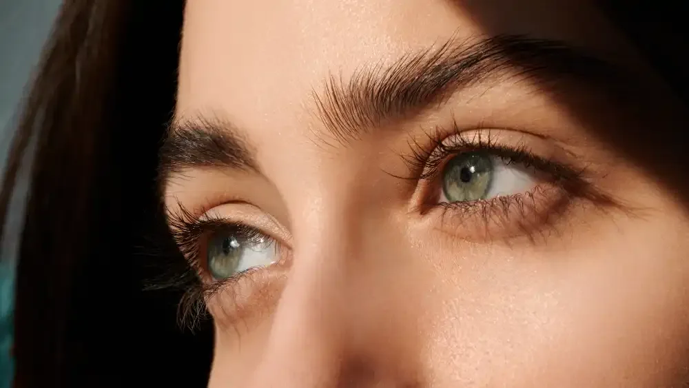 Close-up of a woman's eyes with lash extensions and softly applied makeup.