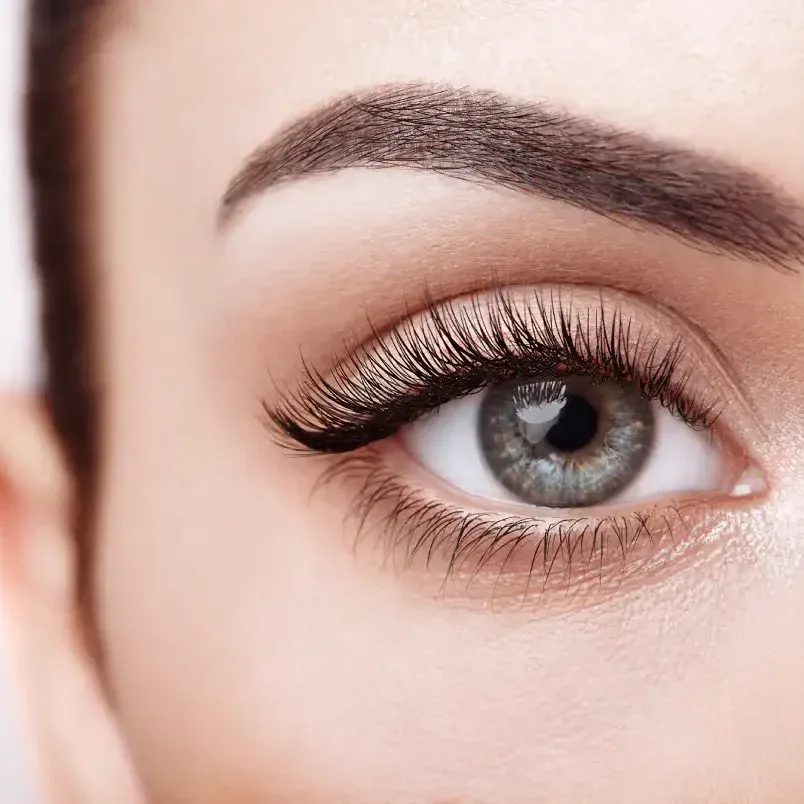 Woman swimming on vacation while wearing water-resistant lash extensions.