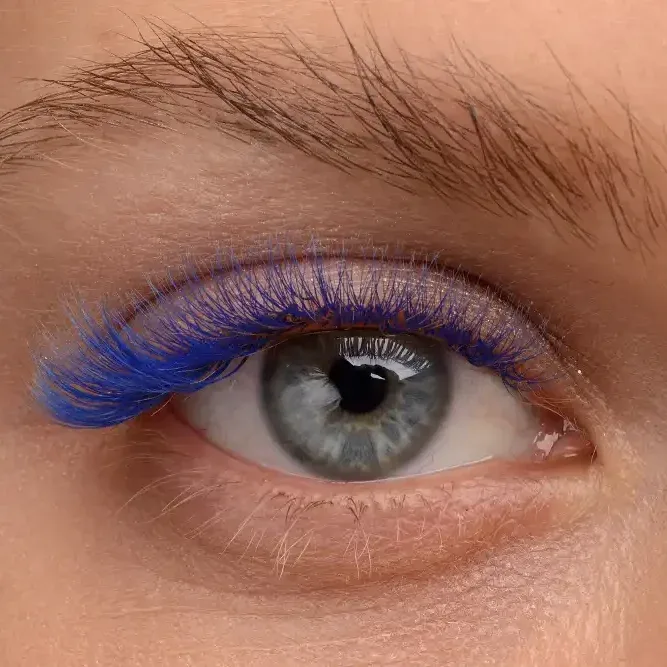 Woman wearing bold blue mega-volume lashes with a glossy wet effect.