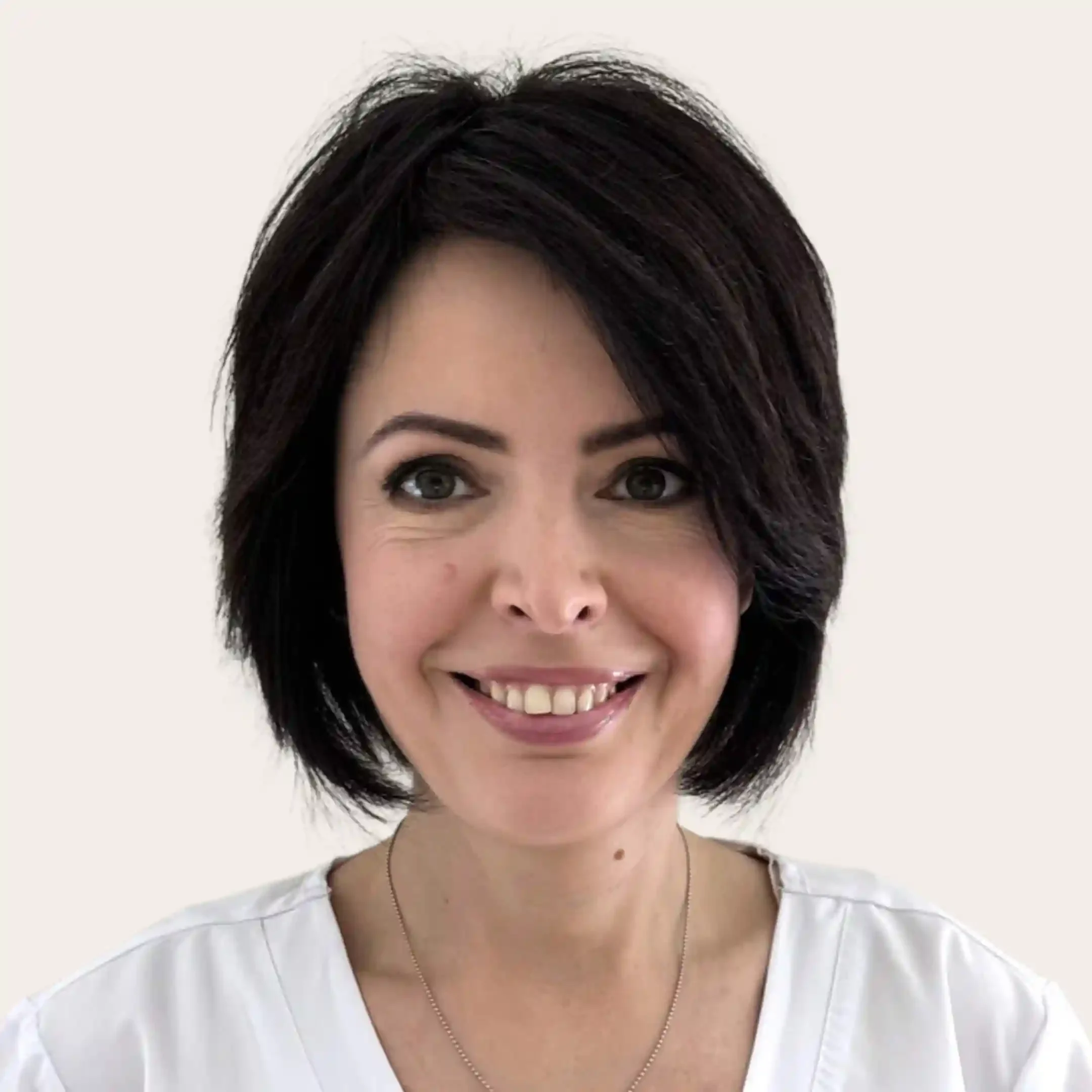 Experienced esthetician Natasha with warm smile, applying 12 years expertise in massage and individual care