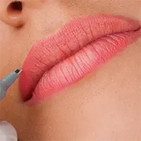 Client receiving lip blushing permanent makeup service with tattooing device for color enhancement