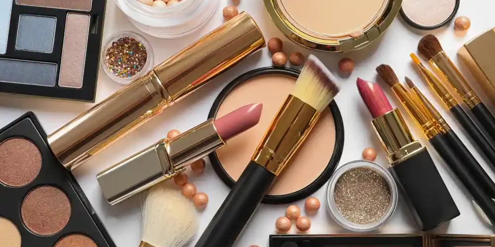A flat lay of various decorative cosmetics, illustrating the importance of choosing products that are safe to use with eyelash extensions.