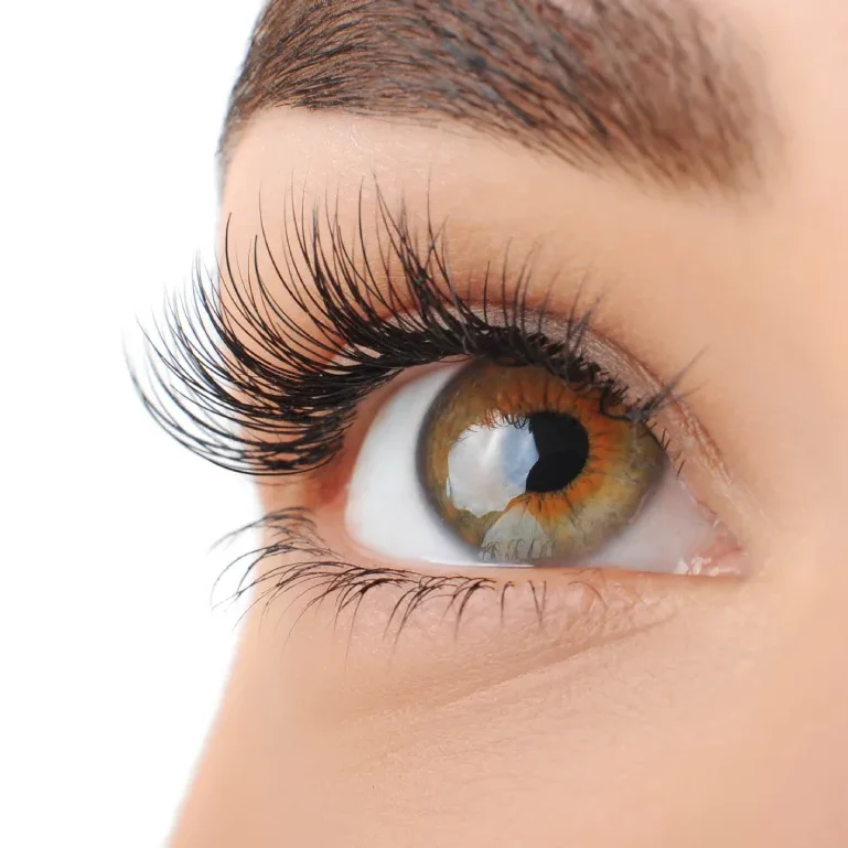 Woman wearing natural classic brown lash extensions with L-curl texture, achieving popular angel eyelashes quiet luxury look