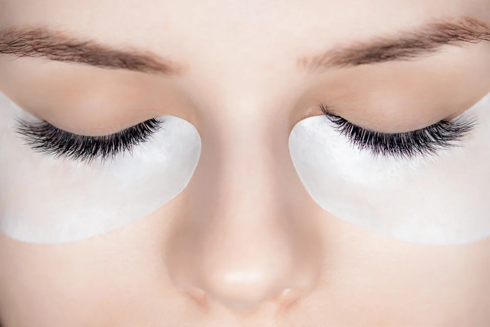 A close-up of a client's eyes showing a finished set of hybrid eyelash extensions, a popular style choice.