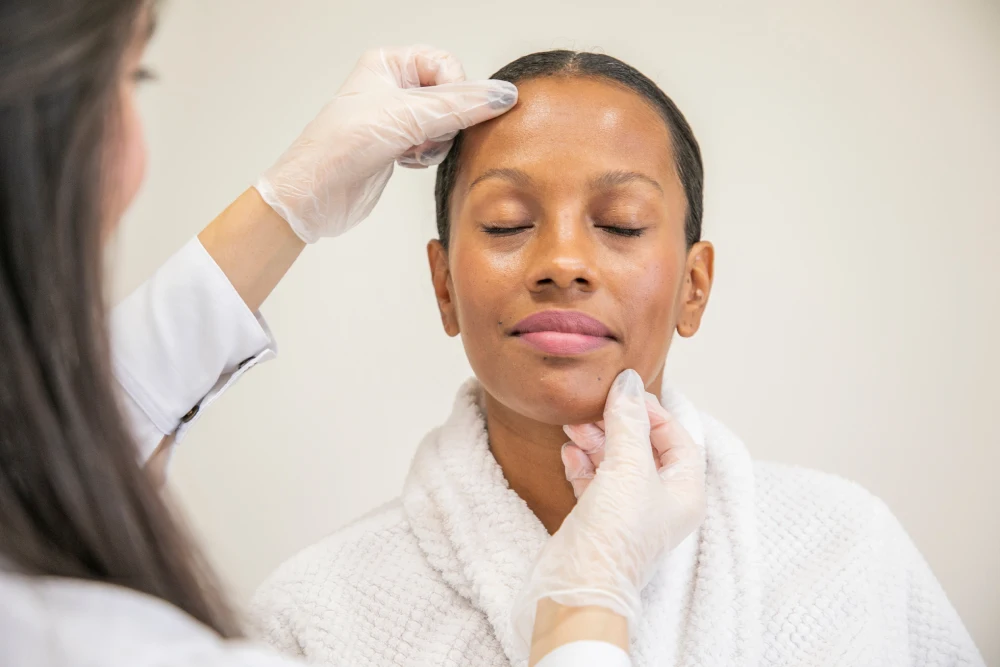 A lash technician discusses the recommended lash style and procedure details with a happy client during a consultation.