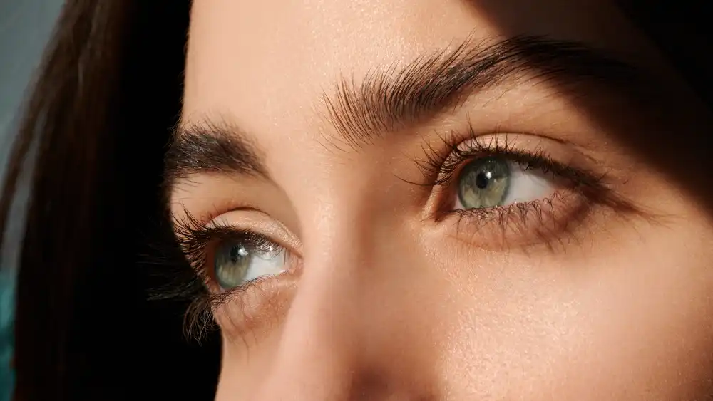 A close-up of a woman's eyes with beautiful extensions, representing the "natural luxury" look achievable with safe makeup practices.